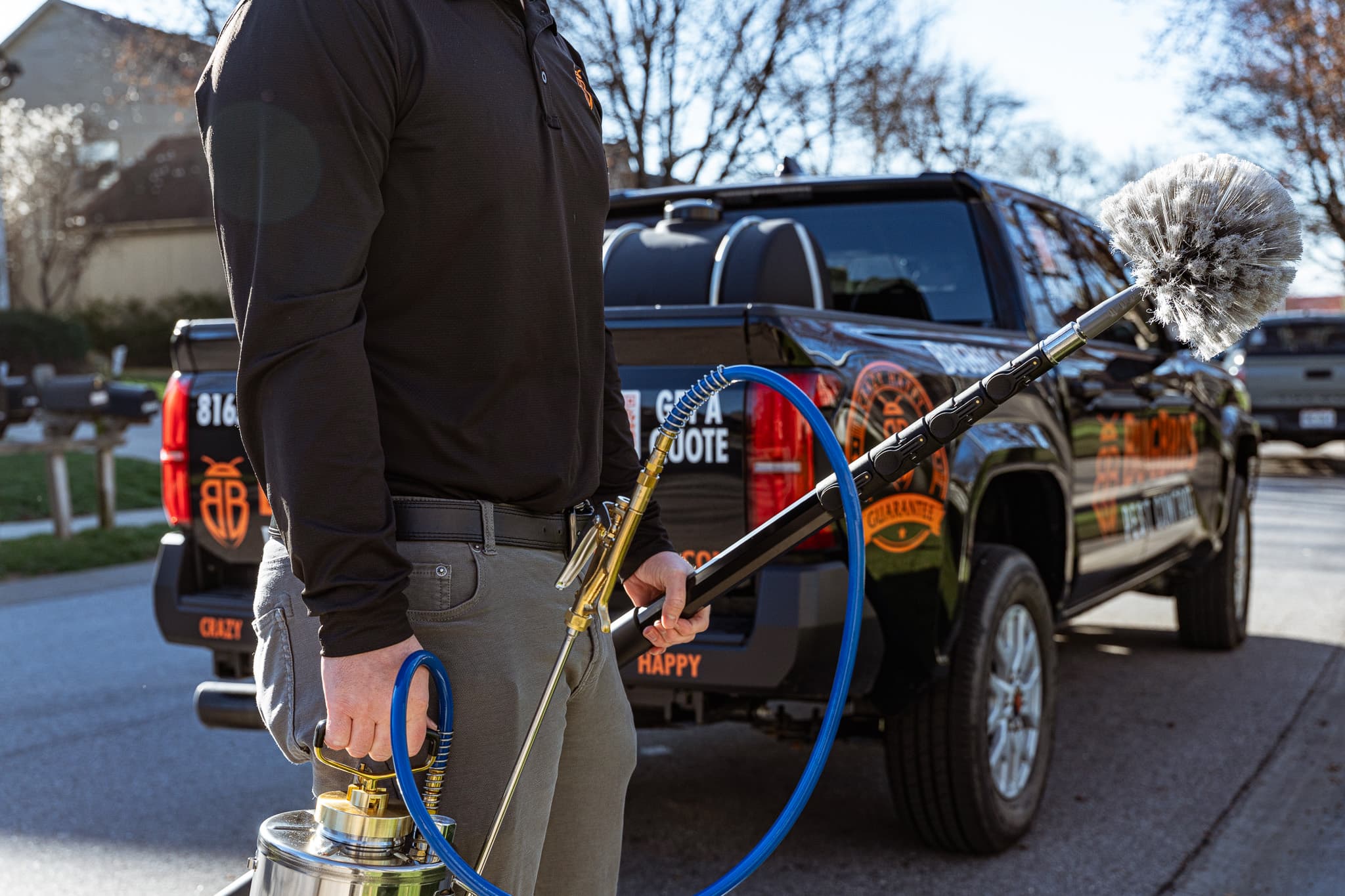 BugBros technician with professional equipment beside branded truck