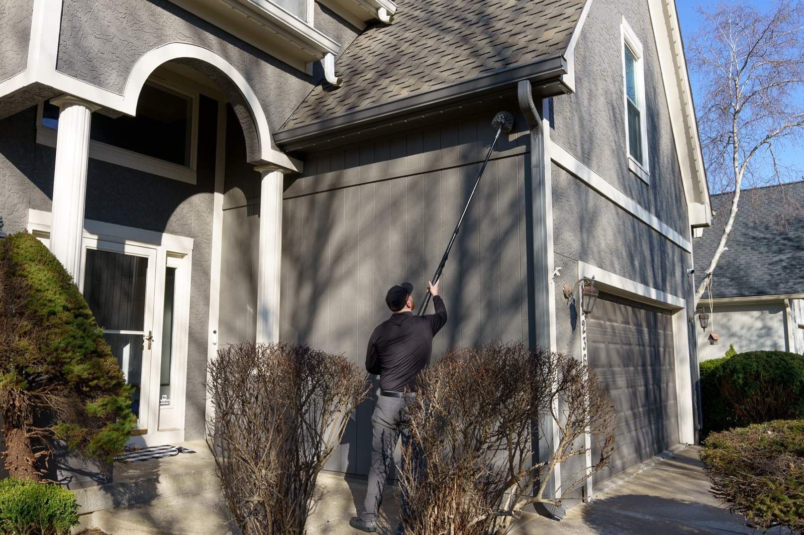 BugBros technician treating the exterior of a Kansas City home