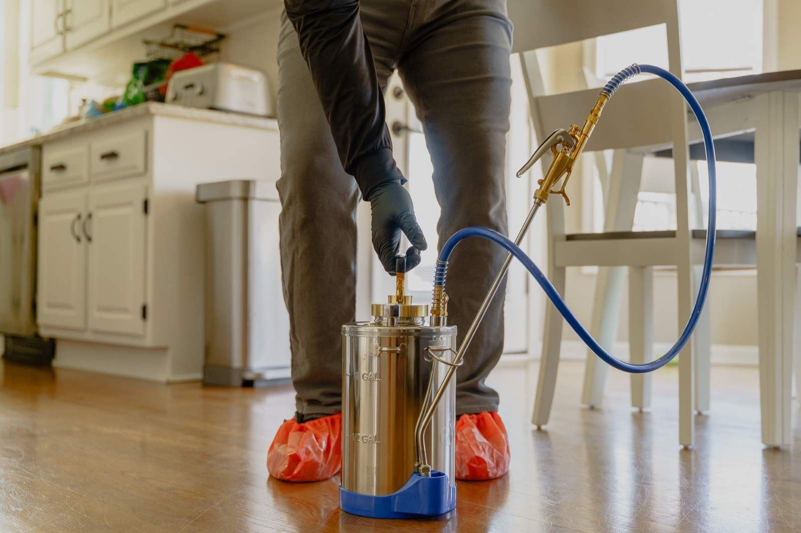 BugBros technician treating the interior of a Kansas City home with professional equipment