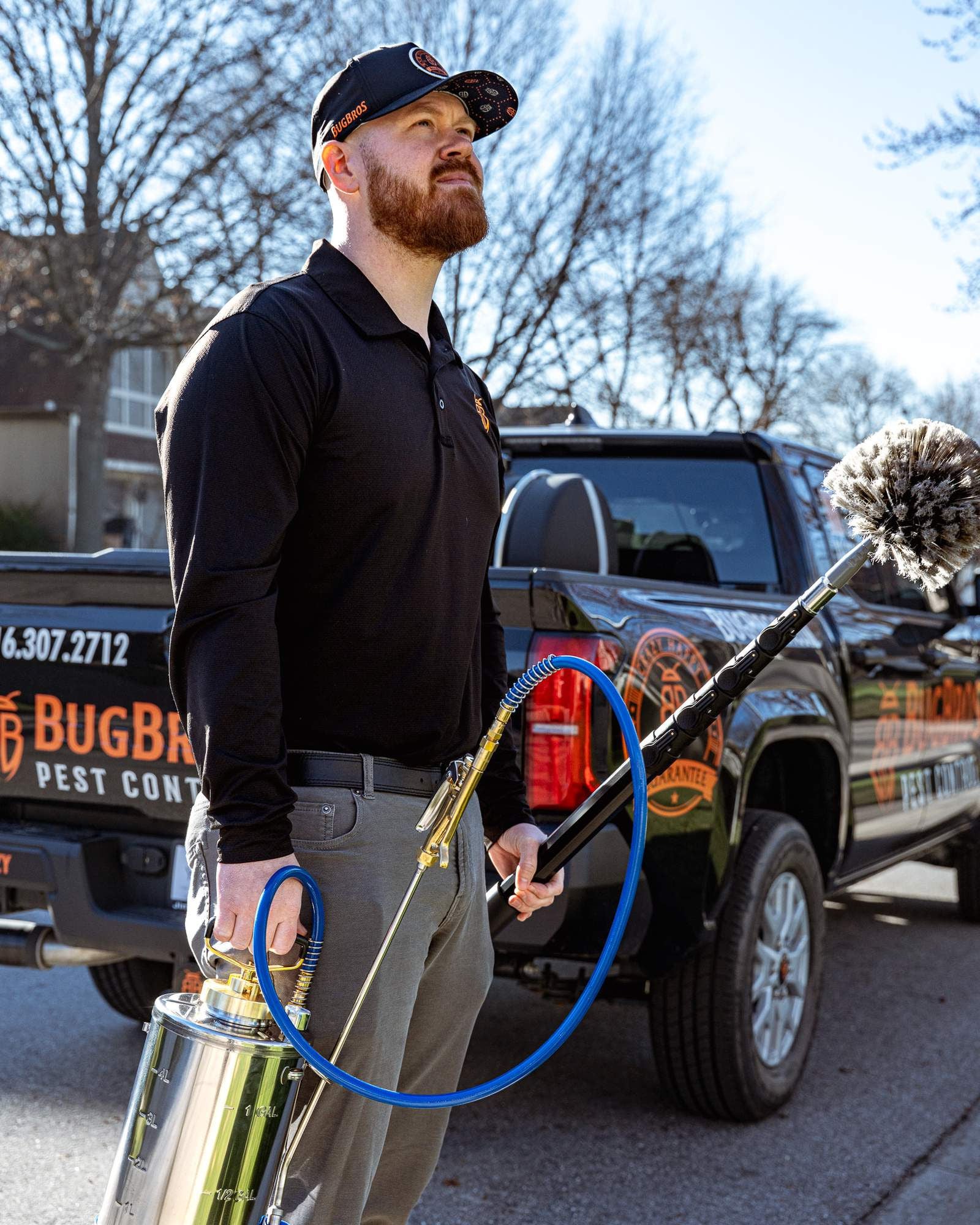 BugBros Pest Control technician standing with professional equipment beside branded truck in Kansas City