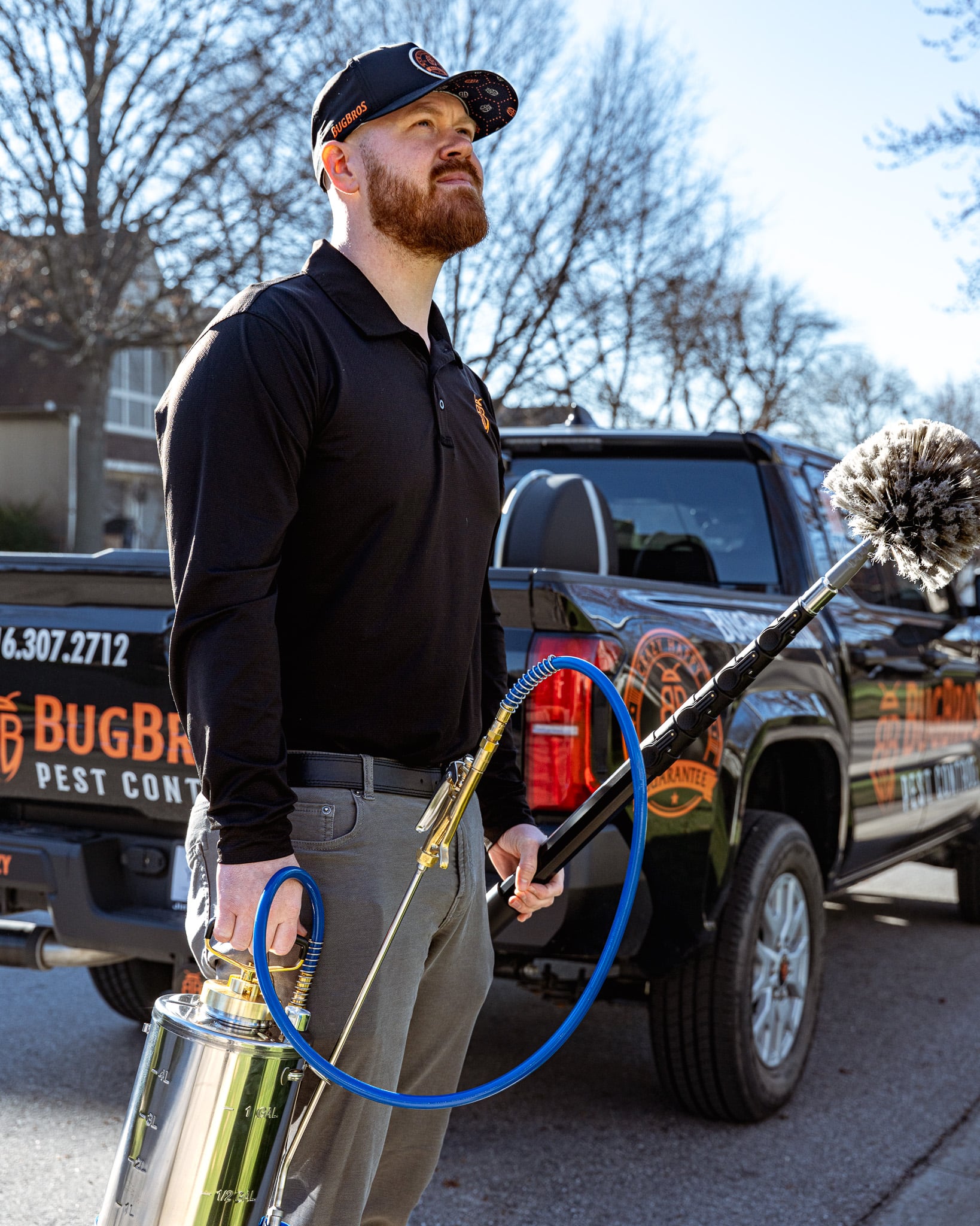 BugBros Pest Control technician standing with professional equipment beside branded truck in Kansas City